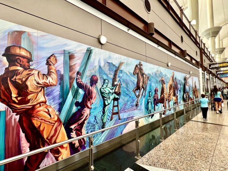 What murals can you see on the walls at the Denver airport?